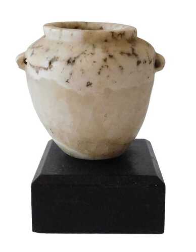An Egyptian alabaster vase, on an ebonised base, 13cm high. Offsite Sale - Buying & Collecting...