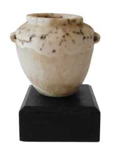An Egyptian alabaster vase, on an ebonised base, 13cm high. Offsite Sale - Buying & Collecting...