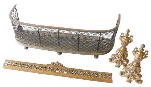 A French gilt metal fender, comprising of two chenet with urns and scrolls, and a centre carpet...