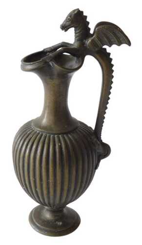 A 19thC bronze Grand Tour style bronze ewer, with dragon handle and reeded body, on inverted...