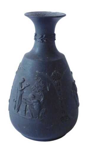 An early 19thC Wedgwood black basalt vase, of tapering circular from, set with classical design...