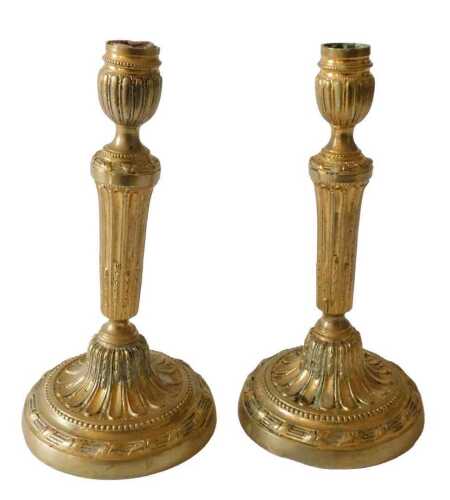 A pair of French late 18thC brass candlesticks, each of classical design, fluted tapering...