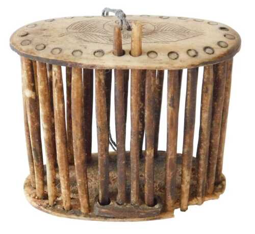 A 19thC Chinese carved bone cricket cage, of oval form, with a repeat studded and floral top,...