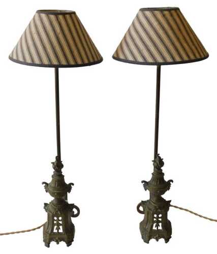 A pair of 19thC French brass chenet, each decorated with a flame finial, bell flowers, scrolls,...