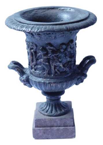 A campana shaped composition urn, decorated with a band of putti, on a square plinth, 30cm high....
