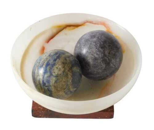 A turned agate bowl, 11cm diameter, two purple stone balls, and a simulated marble stand, 8cm...