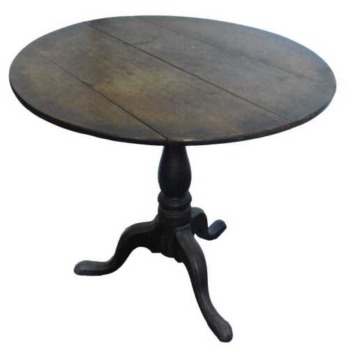 A George III mahogany occasional table, the circular tilt top, on a turned column and tripod...
