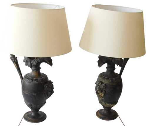 A pair of Continental black painted terracotta urns, with shaped spout, baluster body applied...