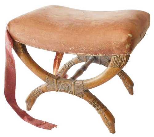 A 19thC French walnut empire style stool, with a brown upholstered seat, on leaf carved X shaped...
