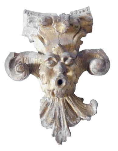 A late 18th/early 19thC giltwood carved fragment, depicting a mask with scrolls, possibly from a...