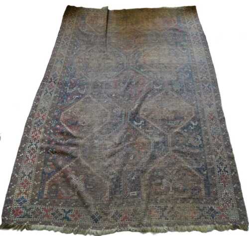 A Persian rug, with a design of pole medallions, on a blue ground, one wide and two narrow...