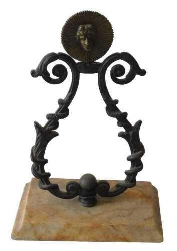A 19thC French gilt metal and marble pocket watch stand, the top mounted with a gilt metal mask...