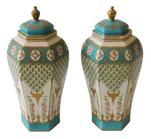 A pair of Japanese porcelain vases and covers, each decorated with pink roses, within circular...