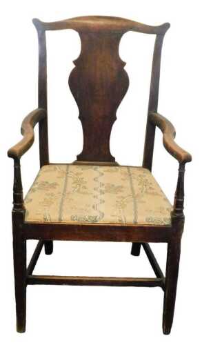 A late 18thC oak country made open armchair, with a solid vase shaped splat, shaped arms and a...
