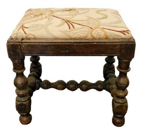 An oak stool, the rectangular top with padded crewelwork seat, on turned supports and H...