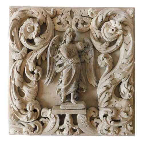 A late 17th/early 18thC Continental carved limewood square panel, centred with an angel, with a...
