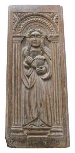 An oak ecclesiastical panel, formed as a saint or maiden in flowing robes holding urn, in an...