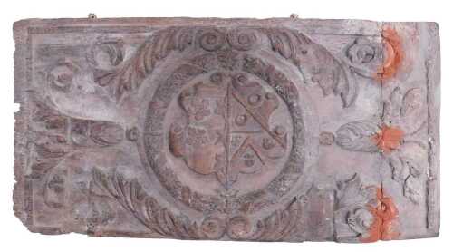A 17thC carved oak panel, of rectangular form, centred with a crest, with acanthus, bell flower...