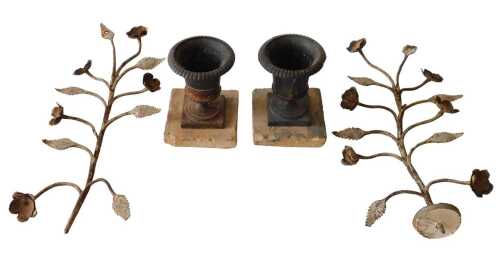 A pair of Grand Tour style iron urns, of campana form, on square stepped part stone base, with...