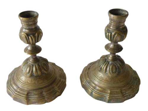 A pair of 19thC silvered brass candlesticks, on inverted stem, partially gadrooned and with...