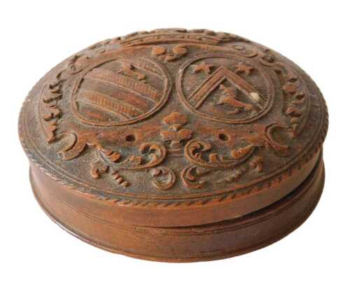 A 19thC French boxwood pill box, of circular form, the removable lid heavily carved with coat of...