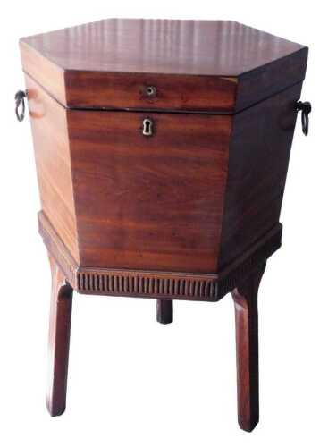 A George III mahogany cellarette, of hexagonal form, with later side carrying handles, on square...