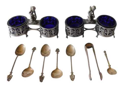 A pair of early 20thC open cruets, with cherubic central handles, and heavily pierced cherub and...