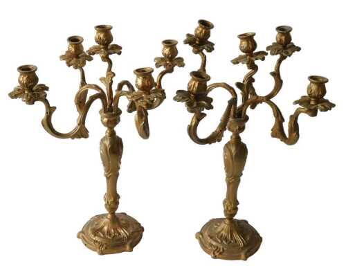 A pair of early 20thC gilt metal five branch candelabrum, each with urn dish holders and floral...