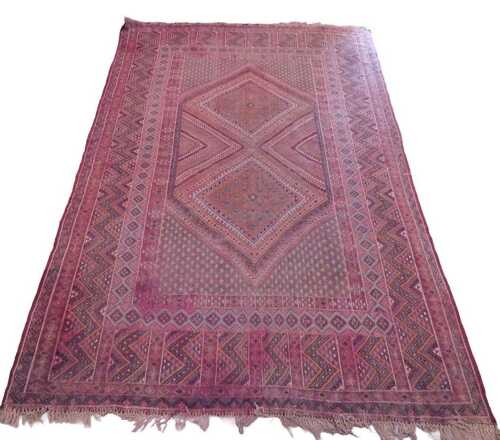 A Turkoman Mushwani carpet, in red, yellow and blue colours, the outer field with a repeat...