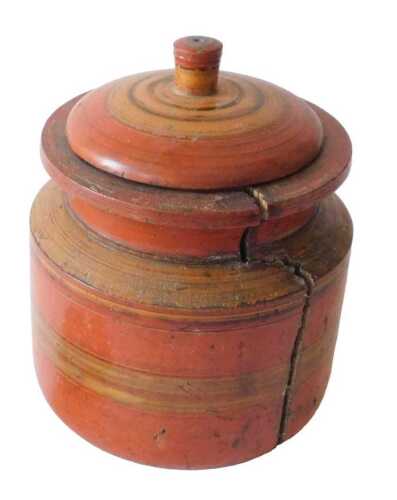 An Indian spice box, of circular form, with domed lid and turned knop, in a red and geometric...
