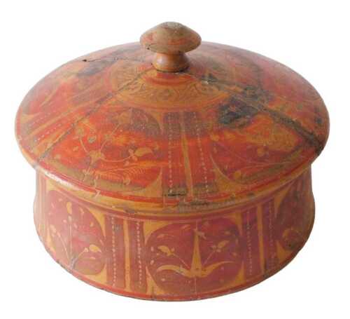 An Indian spice box, of circular form, with domed lid and turned knop, in a red and geometric...