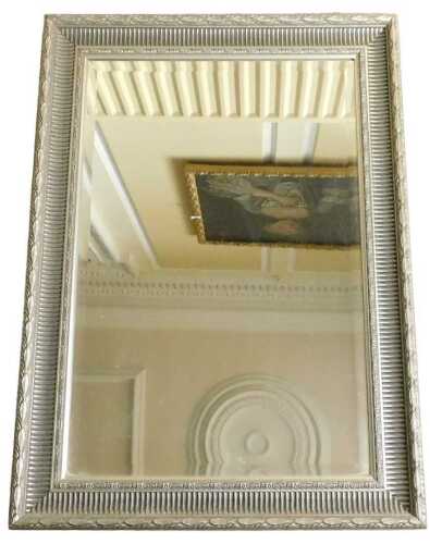 A silvered rectangular wall mirror, with leaf cast and reeded frame surrounding a bevelled plate,...