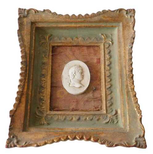 An oval plaster intaglio of a gentleman, mounted into a gilt frame, 22cm x 19cm overall. Offsite...