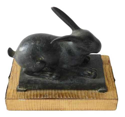 Oriental School. A green patinated bronze figure of a seated rabbit, on rectangular base with...