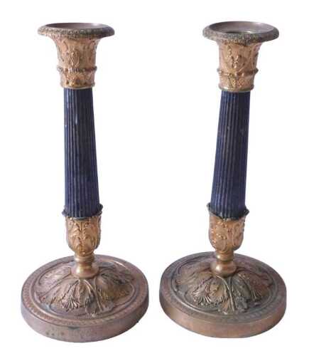A pair of French Empire style gilt metal and bronze effect candlesticks, with reeded column and...