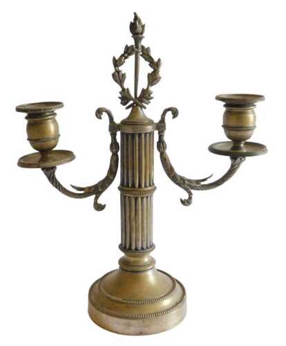 A late 19th/early 20thC French silvered brass two branch candelabra, with part fluted column and...