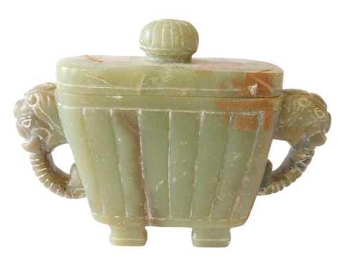 An Oriental green jadeite vessel, with elephant mask handles, 14cm long. Offsite Sale - Buying &...
