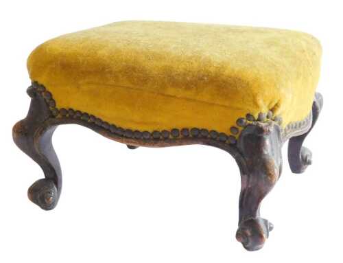 A Victorian mahogany footstool, with a brown upholstered velvet top, on scroll carved feet, 34cm...