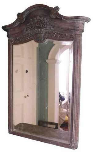 A late 19thC French limed oak overmantel mirror, the crest decorated with scrolls, above a...