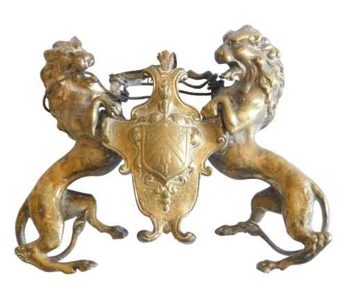 A 19thC French ormolu crest, cast with two heraldic lions surrounding a cartouche, 16cm wide,...