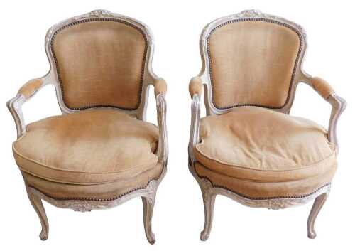 A pair of late 19th/early 20thC French fauteuil, each painted in beige and cream, the moulded...