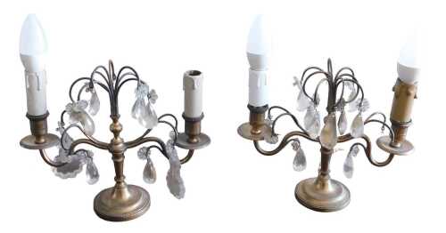 A pair of early 20thC French brass two branch candelabra, the centre suspended with cut glass...