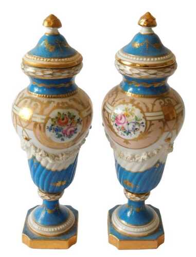 A pair of French Sevres style porcelain vases and covers, each decorated with flower sprays...