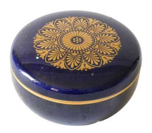 A 20thC French porcelain box and cover, the top decorated with an elaborate gilt roundel, the...