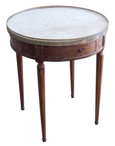 A French mahogany occasional table, the circular marble top with a brass gallery, above two...