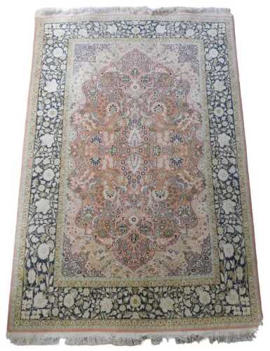 A Persian Sarouk carpet, decorated with flowers, leaves, scrolls, birds, etc., to the central...