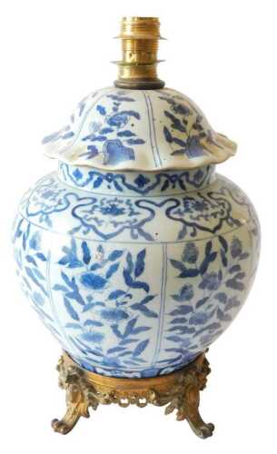 A Chinese porcelain vase and cover in 17thC style, decorated in underglazed blue with flowers,...