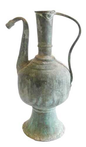 An 18thC Turkish Ottoman copper and tin ewer, with shaped handle, on a tapering base, 36cm high....