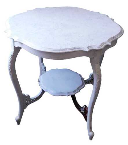 An Edwardian mahogany window table, the shaped top with a moulded edge, on leaf carved cabriole...