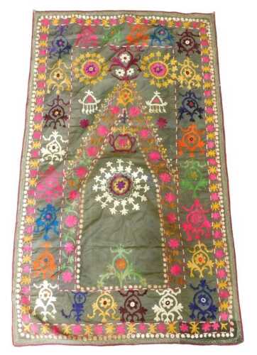 An Eastern Suzani prayer rug, with a design of medallions, on a grey ground. Offsite Sale -...